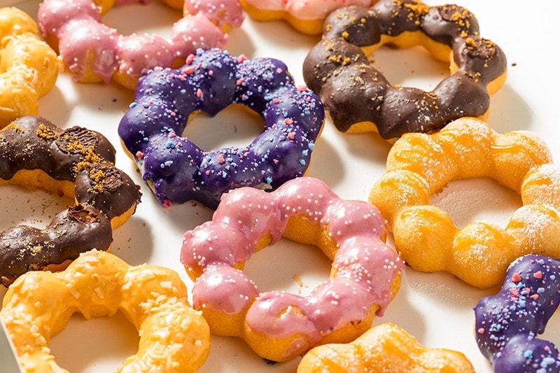 Assorted mochi donuts on a white surface. Assorted mochi donuts on a white surface.