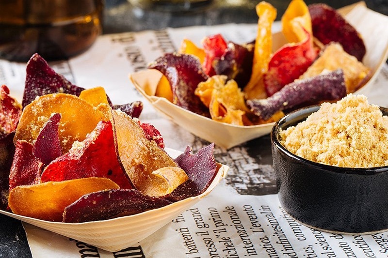 Salted egg chips in serving containers. Salted egg chips in serving containers.