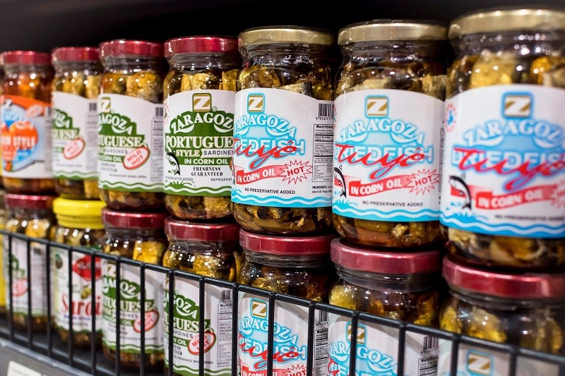 A row of bottled fish products, including sardines and tuyo A row of bottled fish products, including sardines and tuyo