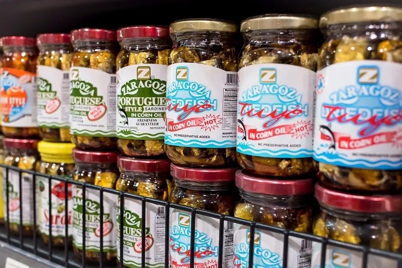 Bottled tuyo, dulong, and tinapa on a grocery shelf. Bottled tuyo, dulong, and tinapa on a grocery shelf.