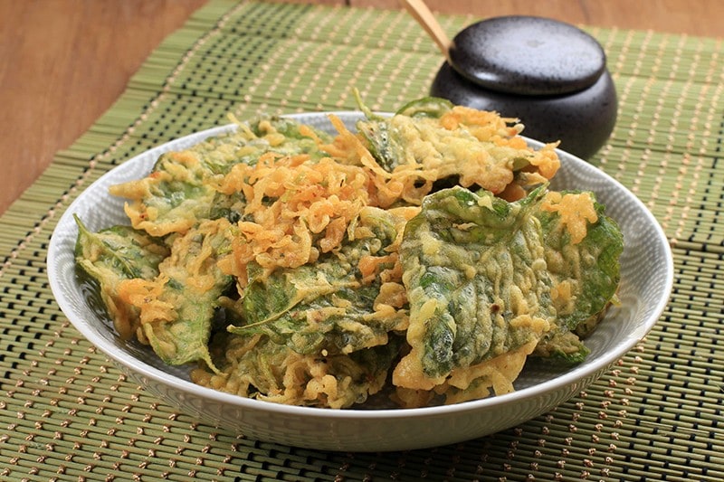 Crispy kangkong chips in a bowl. Crispy kangkong chips in a bowl.
