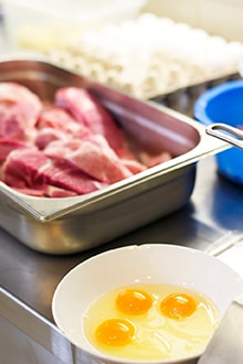 Three scenes in the kitchen featuring eggs and raw meat, fresh pasta, and fresh fruit juice Three scenes in the kitchen featuring eggs and raw meat, fresh pasta, and fresh fruit juice