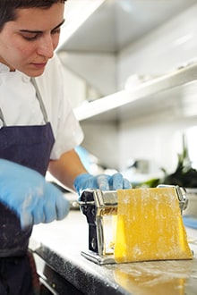 Three scenes in the kitchen featuring eggs and raw meat, fresh pasta, and fresh fruit juice Three scenes in the kitchen featuring eggs and raw meat, fresh pasta, and fresh fruit juice