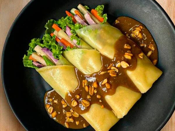 Give fresh lumpia extra texture with crunchy garlic nuts for garnish. Give fresh lumpia extra texture with crunchy garlic nuts for garnish.