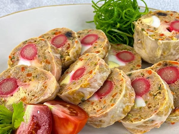  Image alt-text 3: Sliced embutido with hotdogs and eggs on a white platter. 