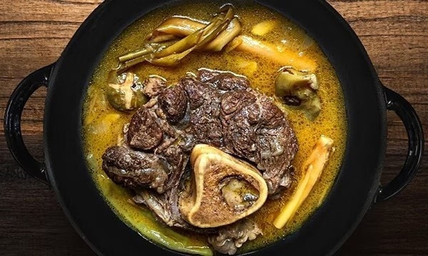 Beef shanks kansi in a black pot.
