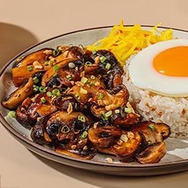 Soy-roasted mushroom silog with atchara and condiments on the side. Soy-roasted mushroom silog with atchara and condiments on the side.