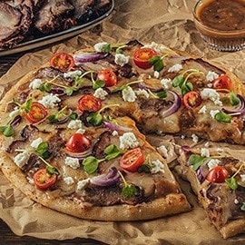 Lechon baka pizza topped with cherry tomatoes and kesong puti. Lechon baka pizza topped with cherry tomatoes and kesong puti.