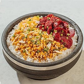 Kalabasa bibimbap with tinapa and chorizo in a traditional stone bowl. Kalabasa bibimbap with tinapa and chorizo in a traditional stone bowl.