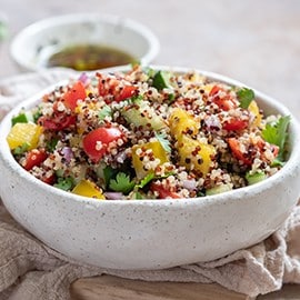 Quinoa and vegetable salad in a white bowl. Quinoa and vegetable salad in a white bowl.