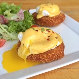 Crab cake Benedict topped with hollandaise sauce. Crab cake Benedict topped with hollandaise sauce.