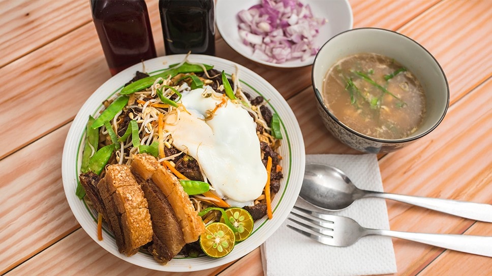 Batil patong with fried pork, vegetables, and egg with soup on the side.