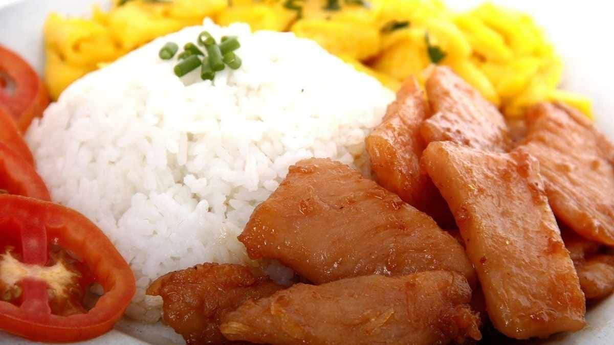 Tocino with rice, scrambled egg, and tomato slices.
