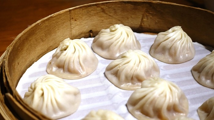 A steamer basket filled with xiao long bao.
