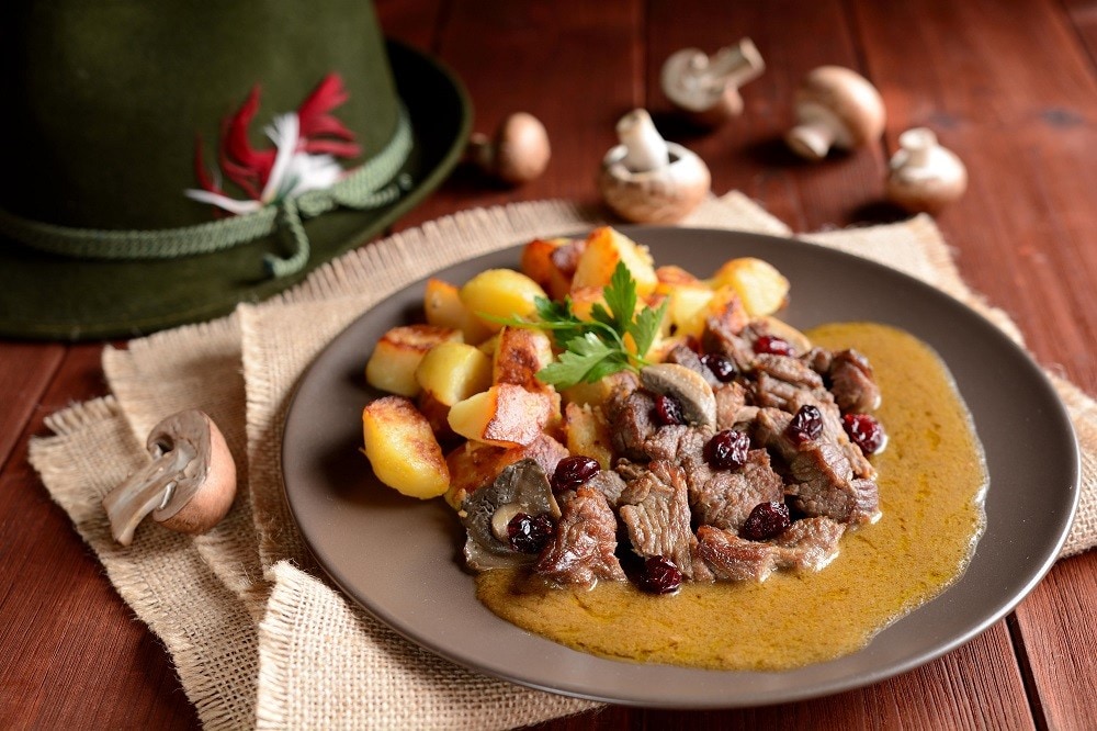 Chopped beef steak with roasted potatoes and mushroom sauce on a plate Chopped beef steak with roasted potatoes and mushroom sauce on a plate