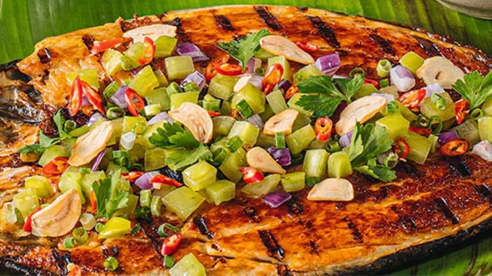 Inihaw na bangus topped with green tomato salad. 