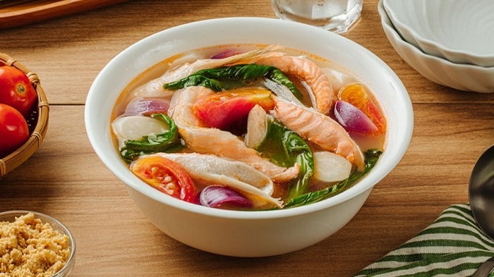 Sinigang na salmon belly sa miso in a white bowl. 