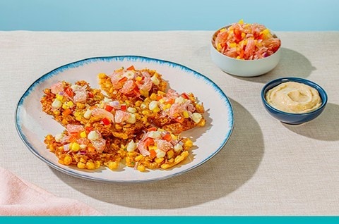 Corn and shrimp okoy topped with burong manga salsa. Corn and shrimp okoy topped with burong manga salsa.