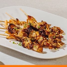 King oyster mushroom inasal on a white plate.  