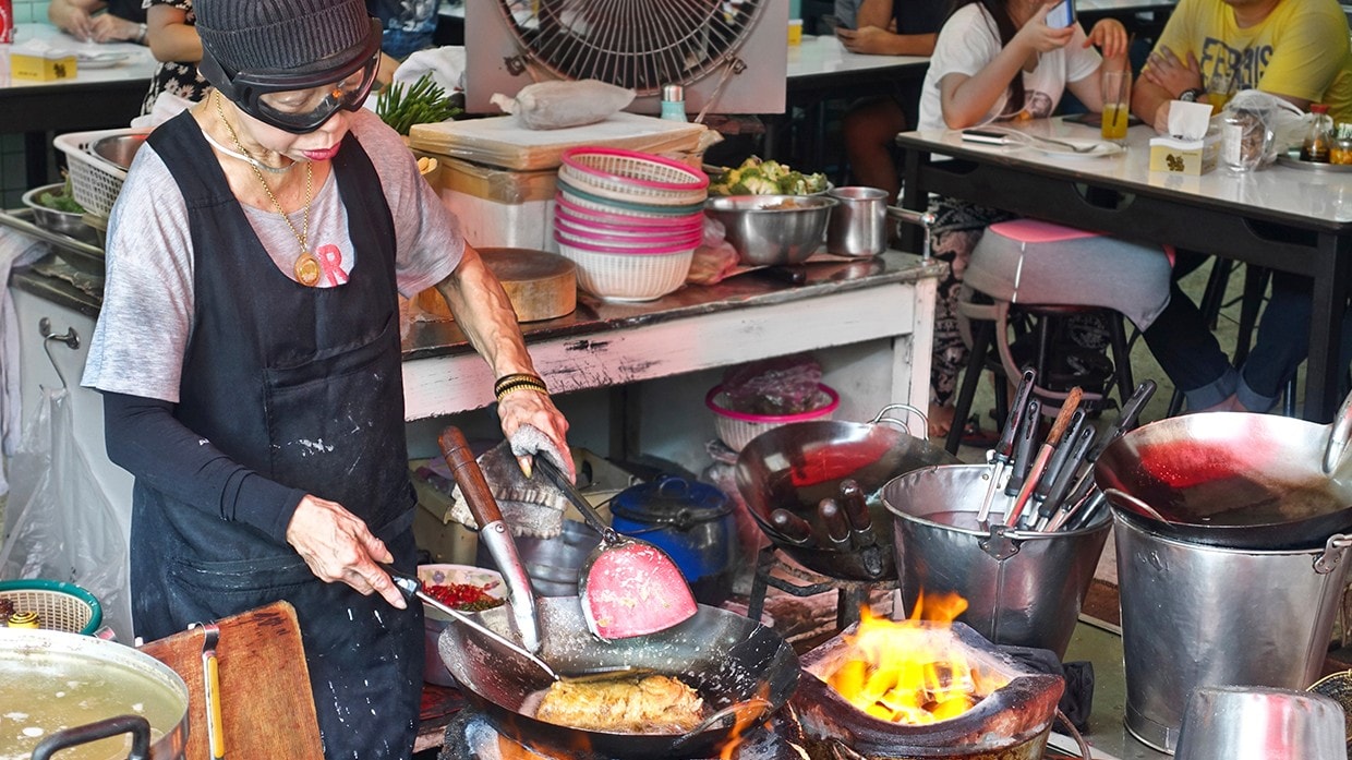 Jay Fai cooking a crab omelet. Jay Fai cooking a crab omelet.