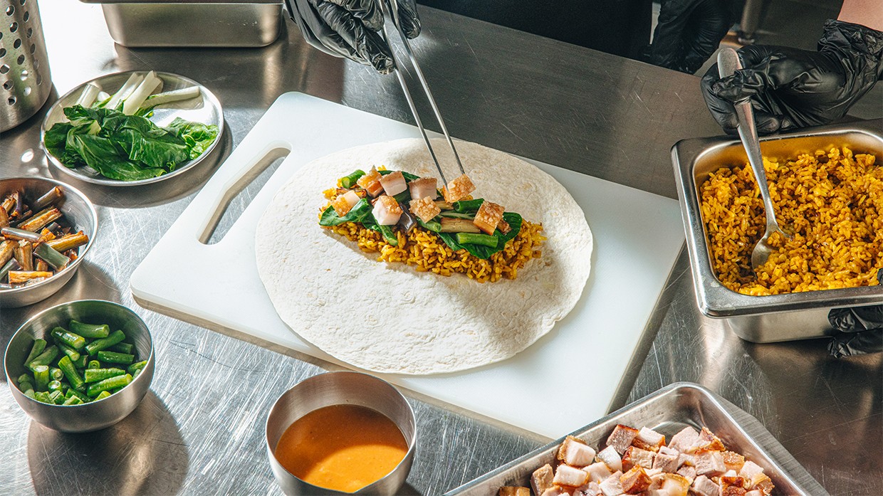 Chefs preparing lechon kawali burrito. Chefs preparing lechon kawali burrito.