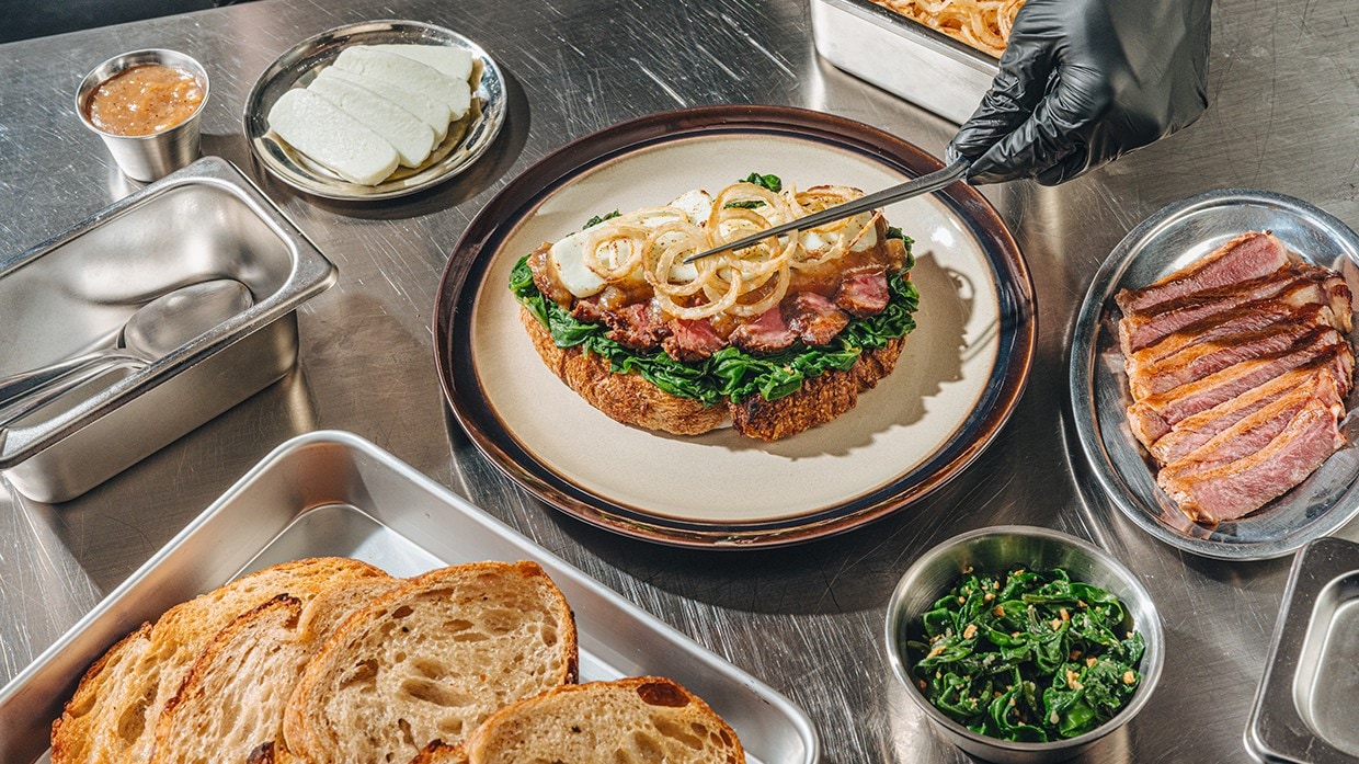 A chef preparing fili bistek sandwich. A chef preparing fili bistek sandwich.