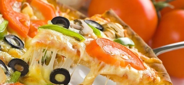 A slice of vegetable pizza with stretchy cheese. A slice of vegetable pizza with stretchy cheese.