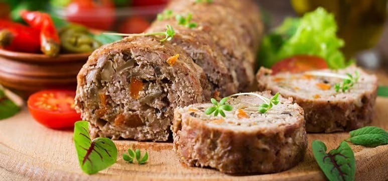 Slices of meat loaf with cubed vegetables mixed in. Slices of meat loaf with cubed vegetables mixed in.