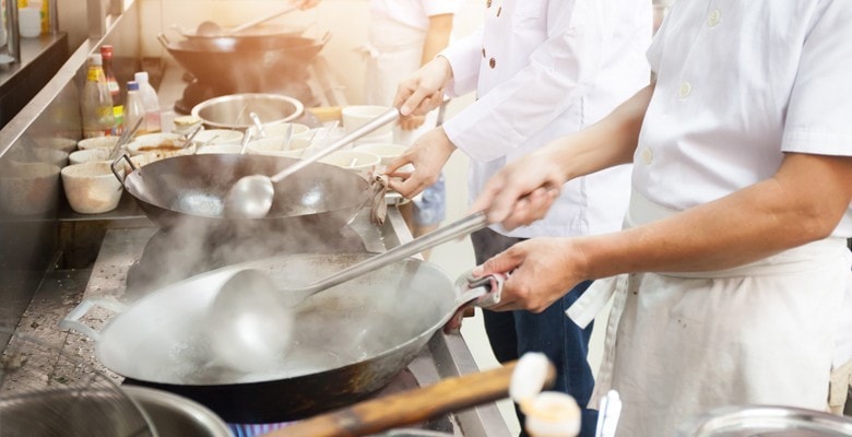 chefs cooking in kitchen