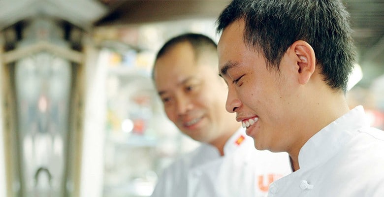 chefs smiling in kitchen