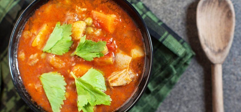 A tomato-based stew of various vegetables, topped with fresh parsley leaves. A tomato-based stew of various vegetables, topped with fresh parsley leaves.