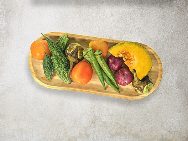 Key Ingredients of Pinakbet on a Wooden Platter Key Ingredients of Pinakbet on a Wooden Platter