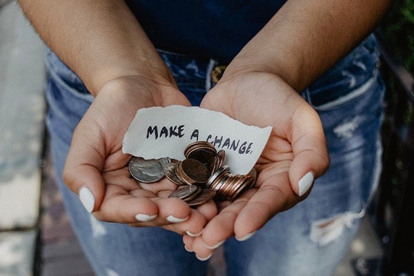 Close-up shot of hand holding coins