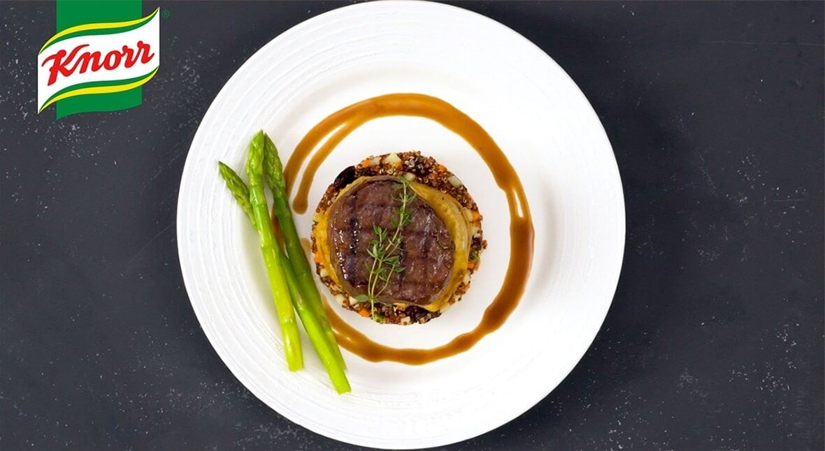 meat dish with asparagus on plate