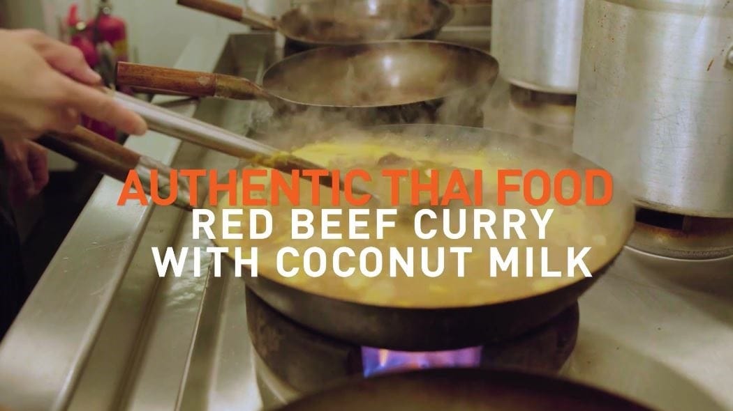 Pan of food with text that reads: Authentic Thai food red beef curtry with coconut milk