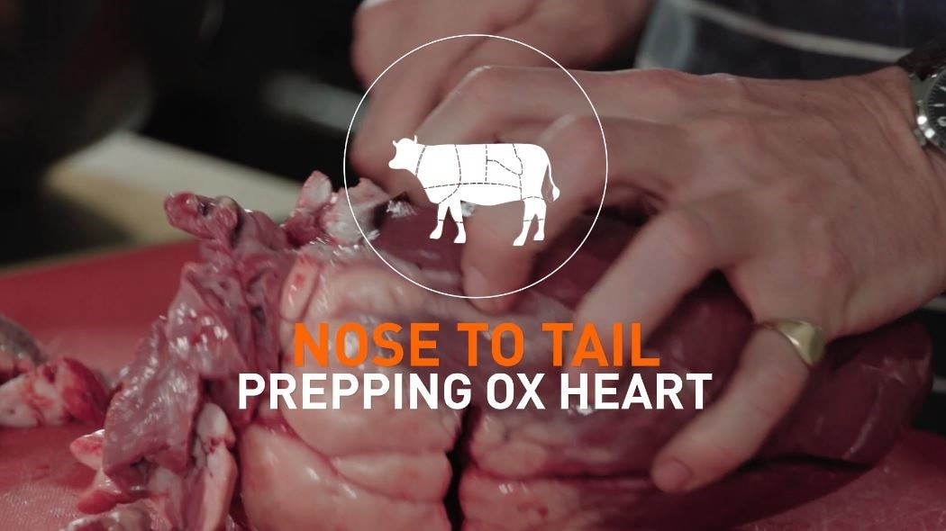 Chef prepping meat with text that reads: Nose to tail - prepping ox heart.