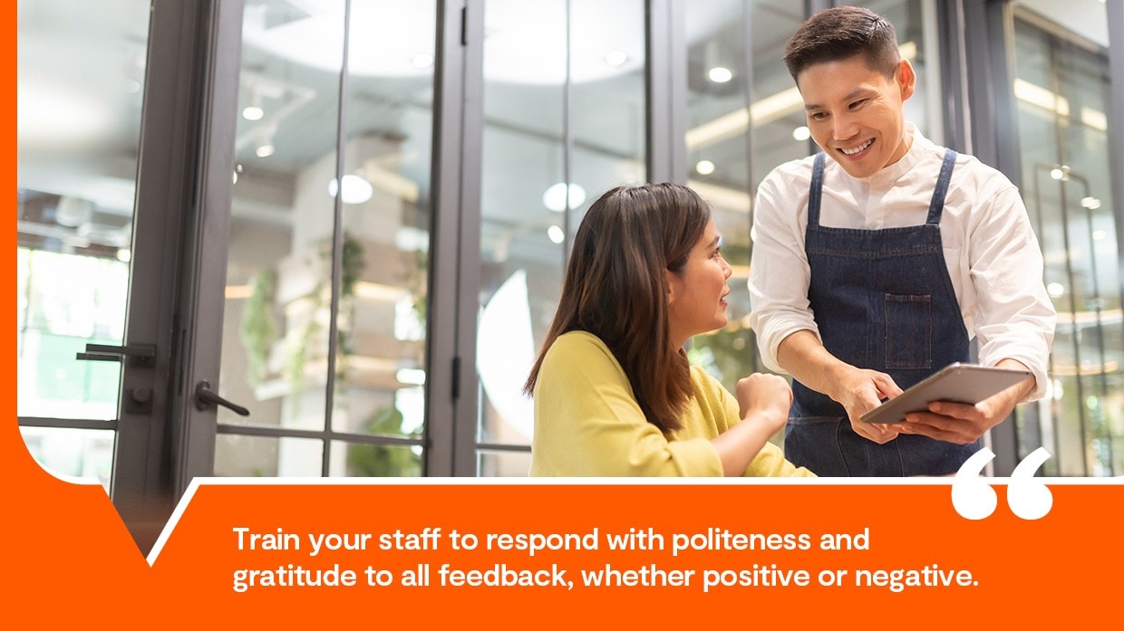 A smiling man reviewing customer feedback. A smiling man reviewing customer feedback.