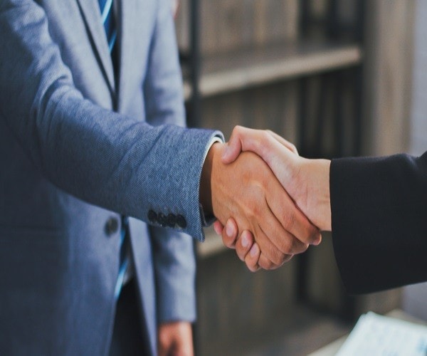 Asian businessman shaking hands partnership deal business while standing indoors in the office, Happy confident Asian boss accept handshaking employer getting hired at a new job.