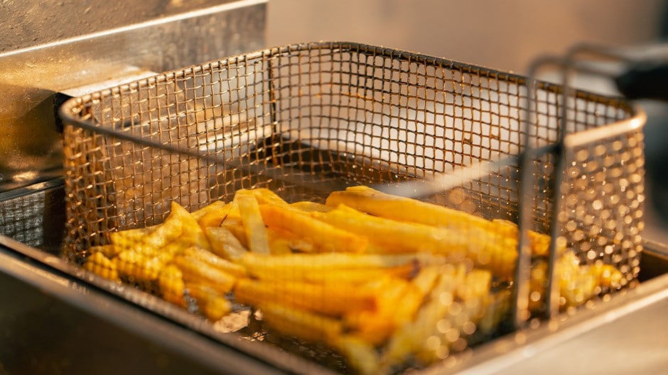 French fries cooked in a deep fryer.