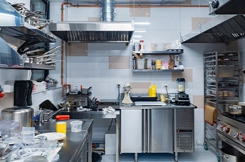 A small commercial kitchen with stainless steel equipment. A small commercial kitchen with stainless steel equipment.