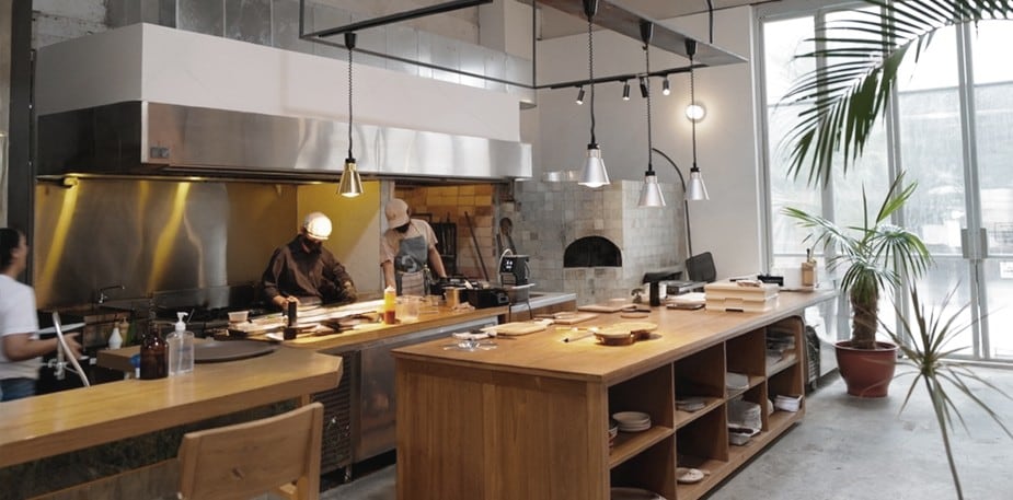 A small commercial kitchen with stainless steel equipment.