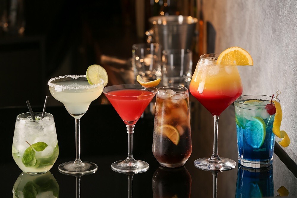An assortment of 6 different types of cocktails on a table An assortment of 6 different types of cocktails on a table