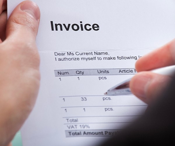 A man holding an invoice. A man holding an invoice.