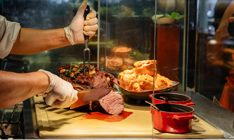 The carving station at a buffet restaurant. 