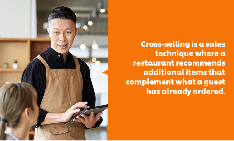 A waiter taking orders from a customer through a tablet.