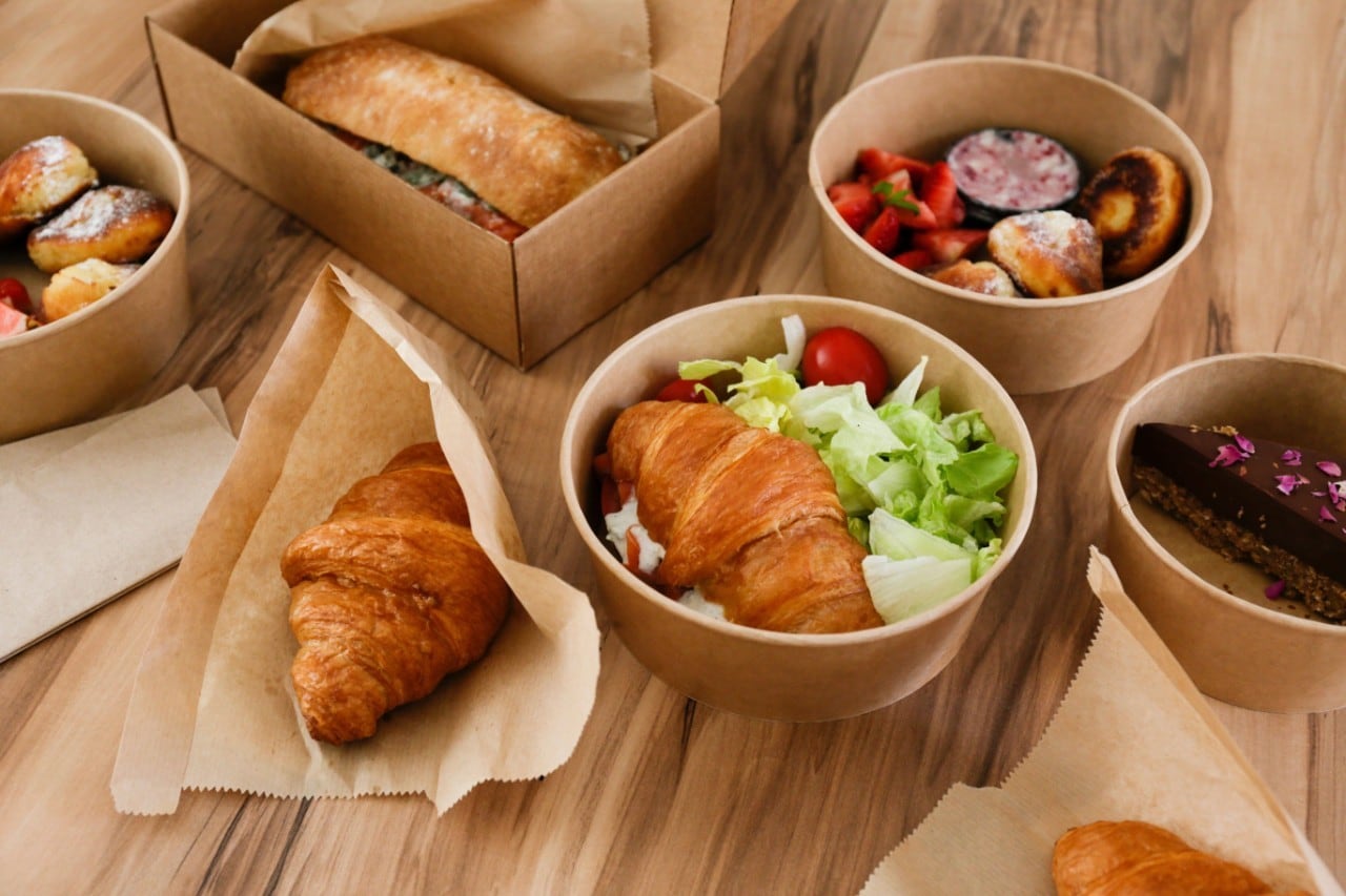 Various food, including croissants, sandwiches, and pastries, in eco-friendly containers.Various food, including croissants, sandwiches, and pastries, in eco-friendly containers.Various food, including croissants, sandwiches, and pastries, in eco-friendly containers.Various food, including croissants, sandwiches, and pastries, in eco-friendly containers. Various food, including croissants, sandwiches, and pastries, in eco-friendly containers.Various food, including croissants, sandwiches, and pastries, in eco-friendly containers.Various food, including croissants, sandwiches, and pastries, in eco-friendly containers.Various food, including croissants, sandwiches, and pastries, in eco-friendly containers.