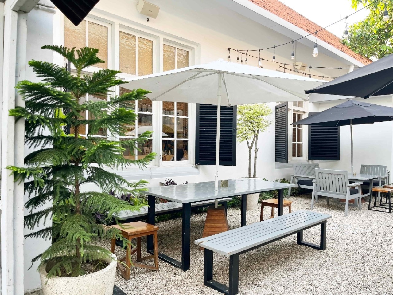 Outdoor seating in a café with benches and bistro umbrellas. Outdoor seating in a café with benches and bistro umbrellas.