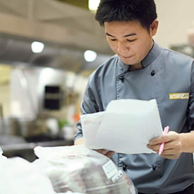 Restaurant owner reading contract Restaurant owner reading contract