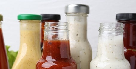 Different types of bottled dips and sauces. 