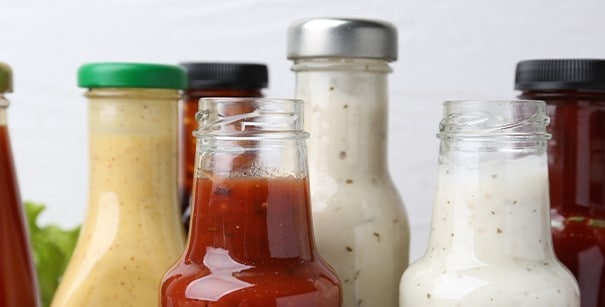 Different types of bottled dips and sauces. 